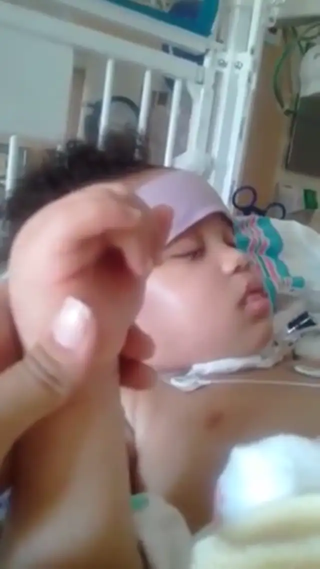 Israel Stinson's signs of life, squeezes hand